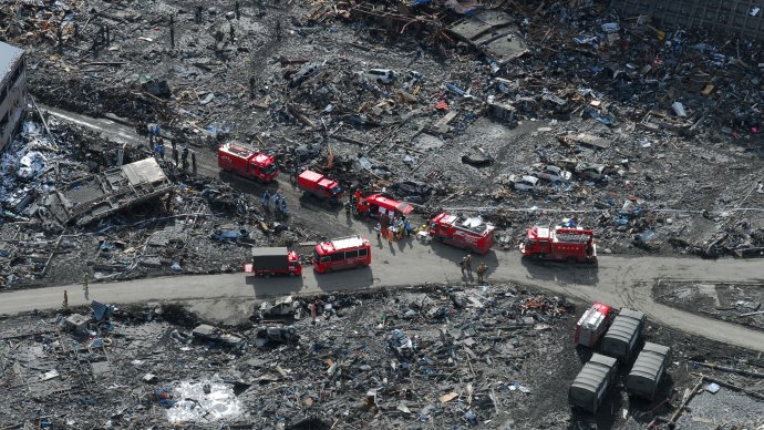 Emergency vehicles search for victims of earthquake/tsunami.