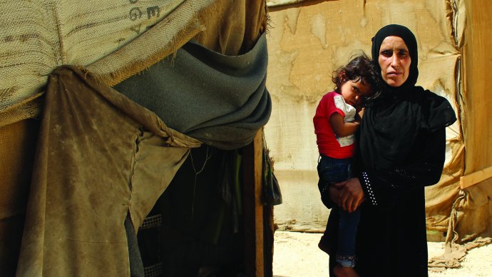 Lady with child by her tent in rural Jordan